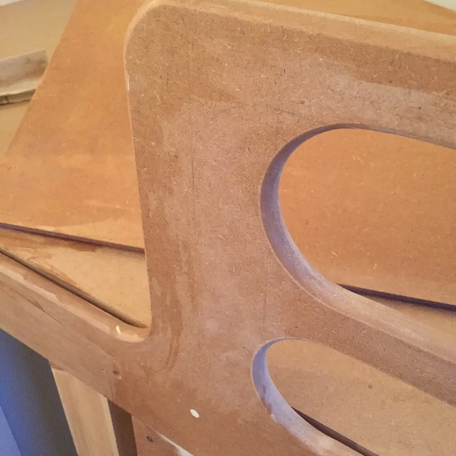 Close-up of an MDF bed end with two rounded cut-outs
