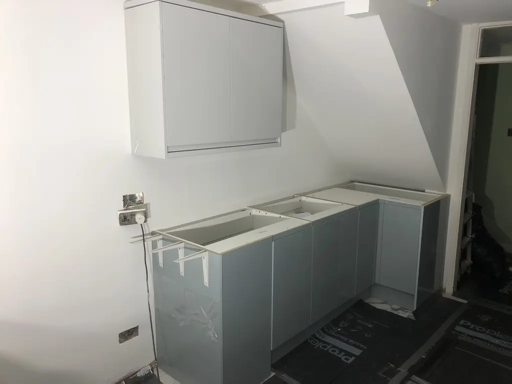 Grey gloss base units and wall cabinet fitted, worktops not yet on