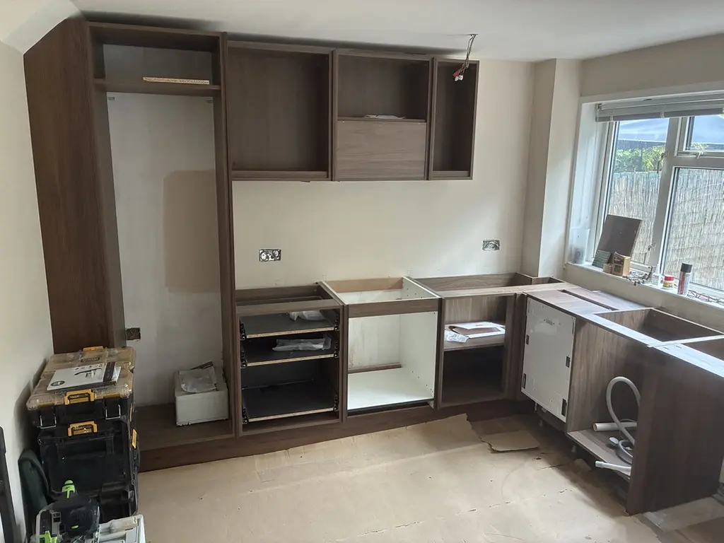 Mid-fit: carcasses and tall housing in, before doors and worktops, Harpenden