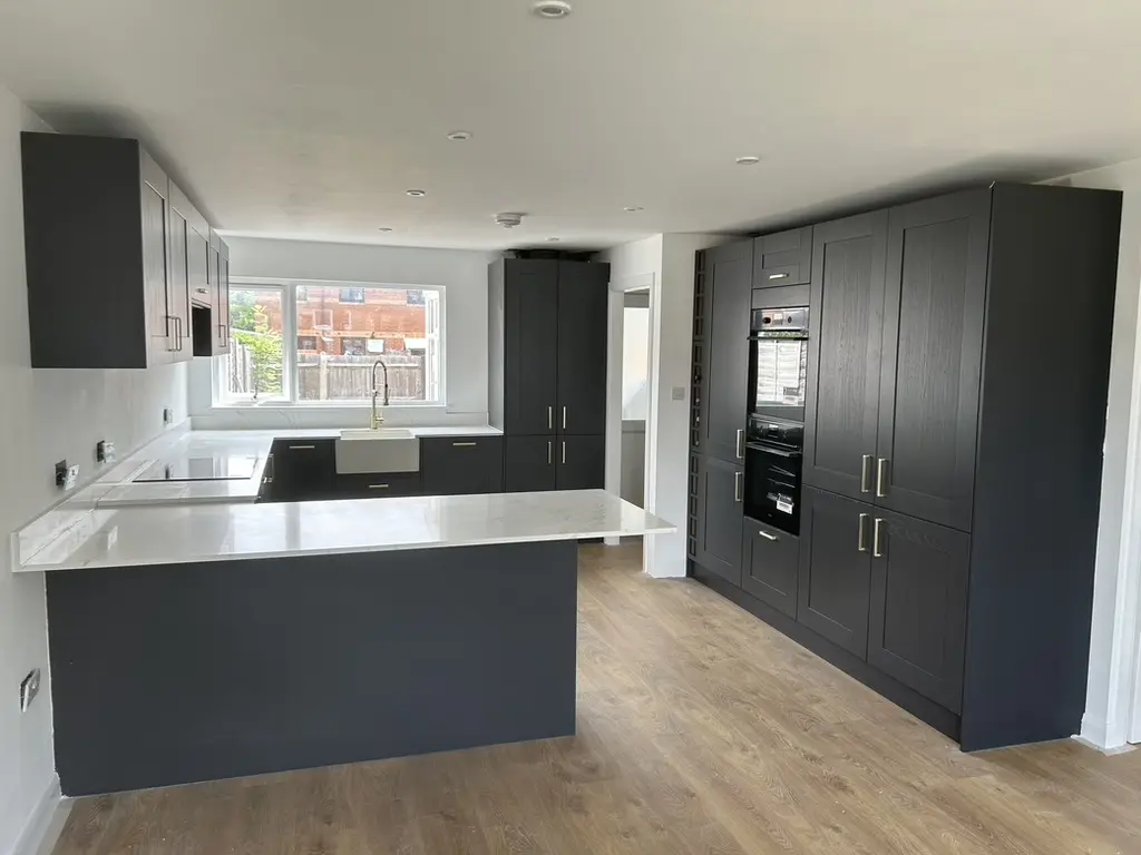 Charcoal shaker kitchen with tall units and white quartz