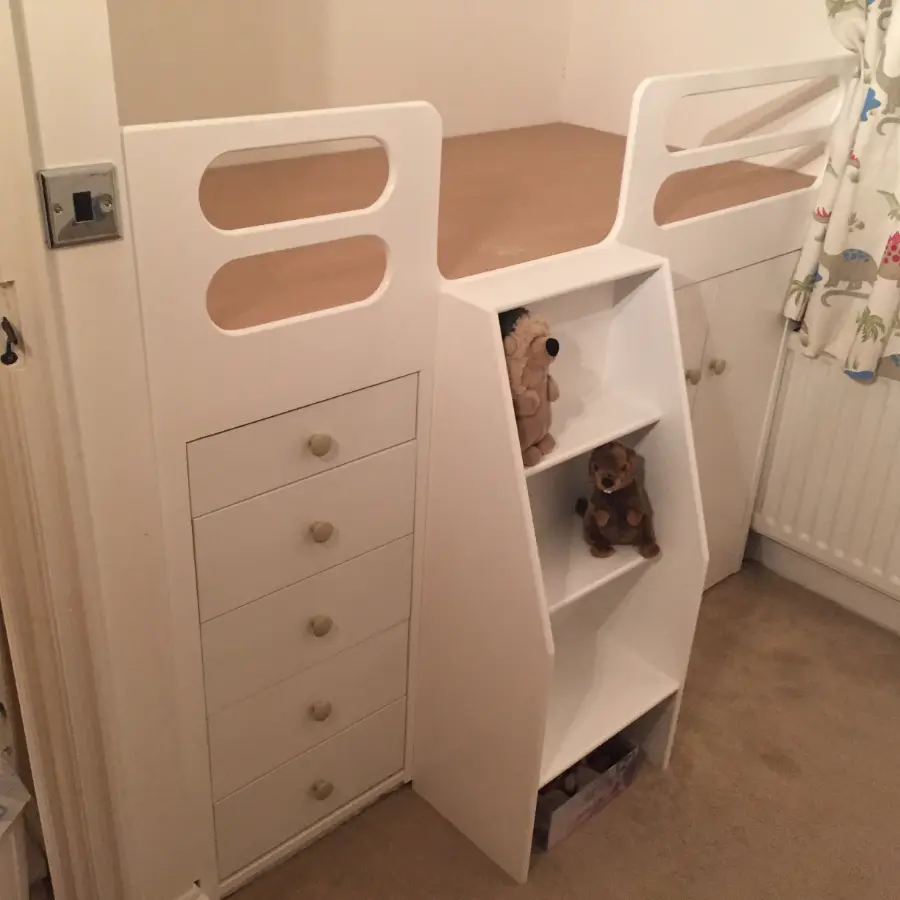 Child's cabin bed with built-in drawers and display shelves