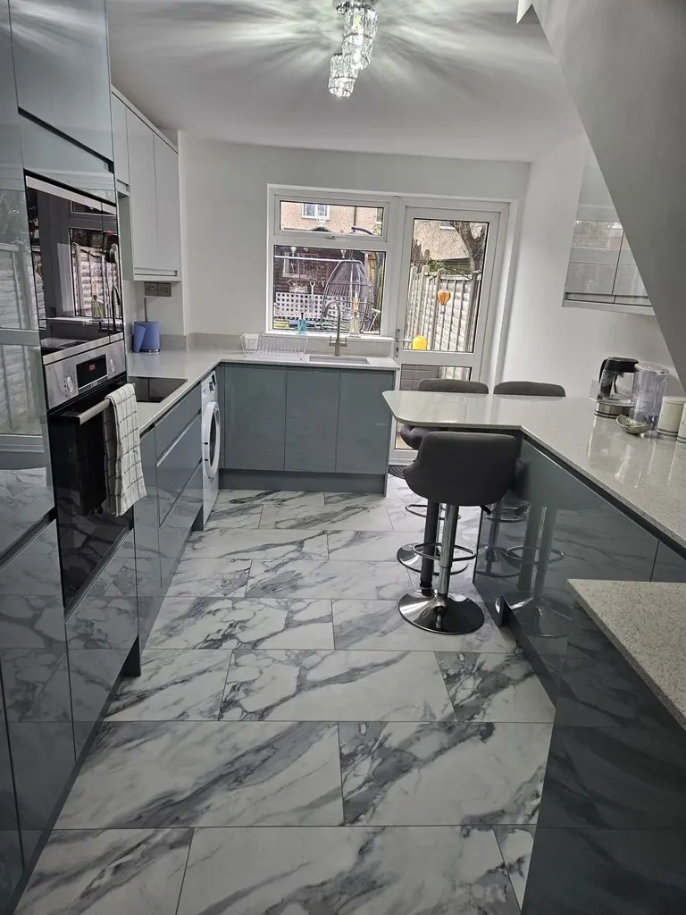 After: the same room, grey gloss handleless with a breakfast bar, Stevenage