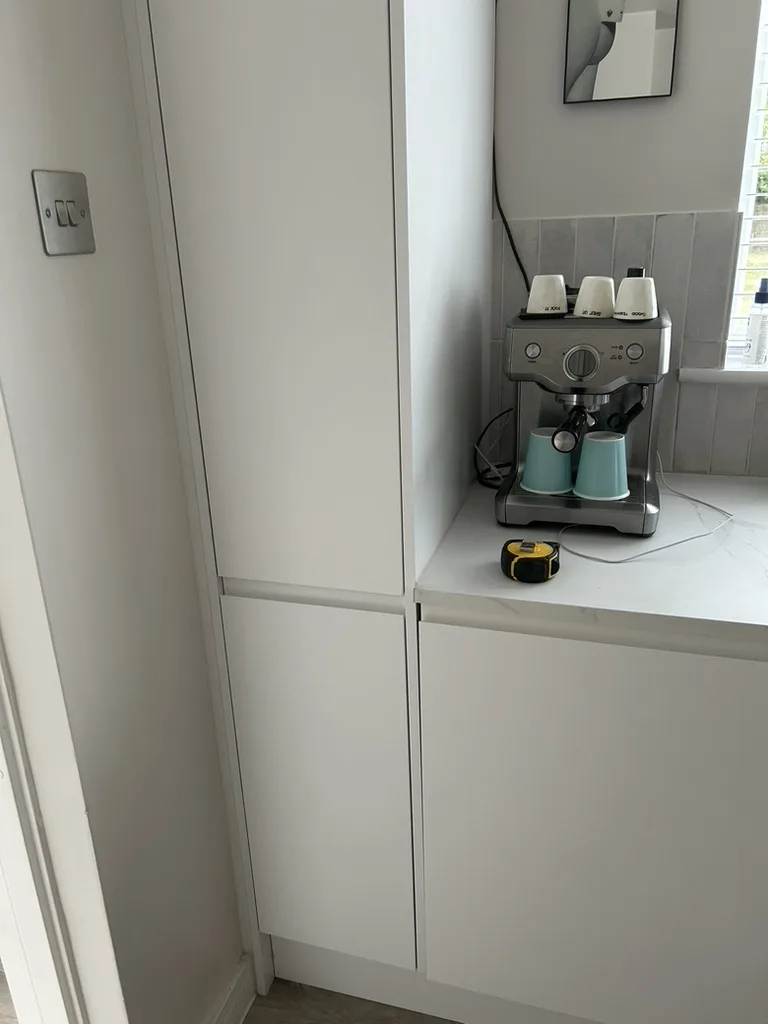 The same Harpenden Howdens kitchen: tall housing by the door